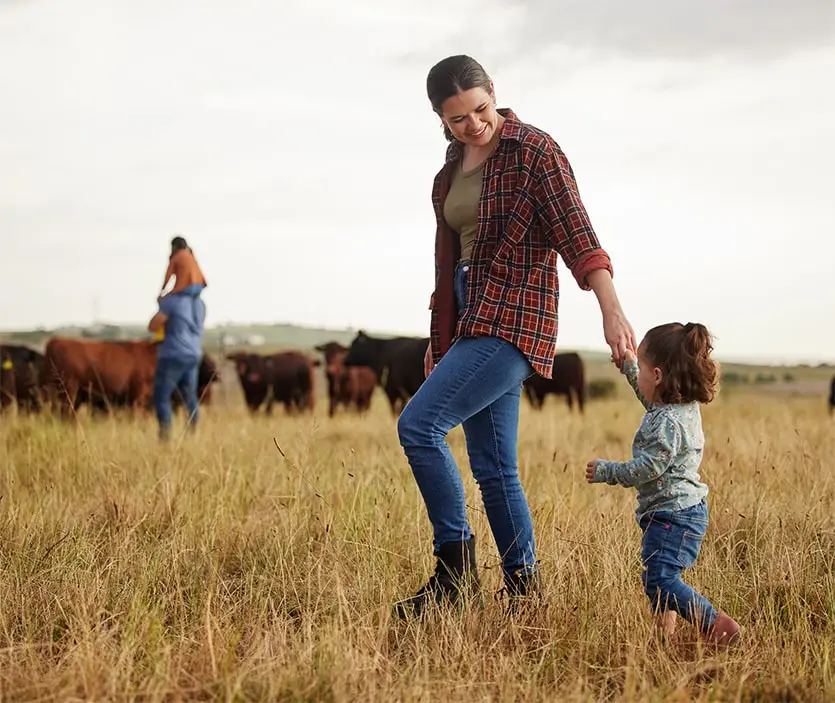 Parents and their children out in a cow pasture